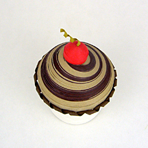 mocha frosting with a cherry garnish