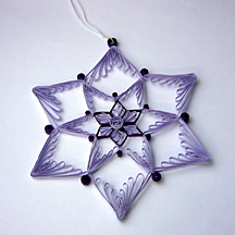 Quilled star made with purple paper